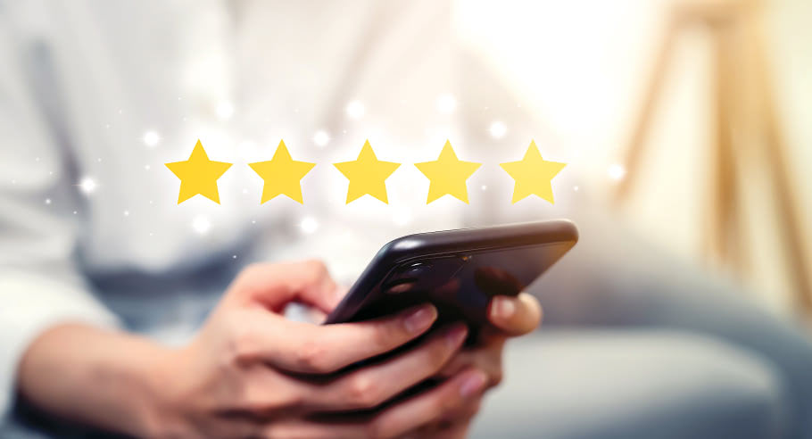 Person holding phone with five yellow stars over image